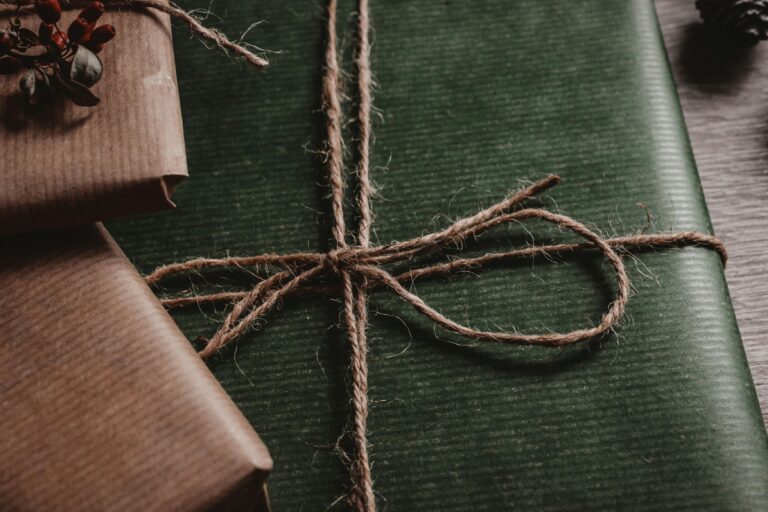 Close-up of rustic styled gift wrapping with green paper and twine, perfect for special occasions.