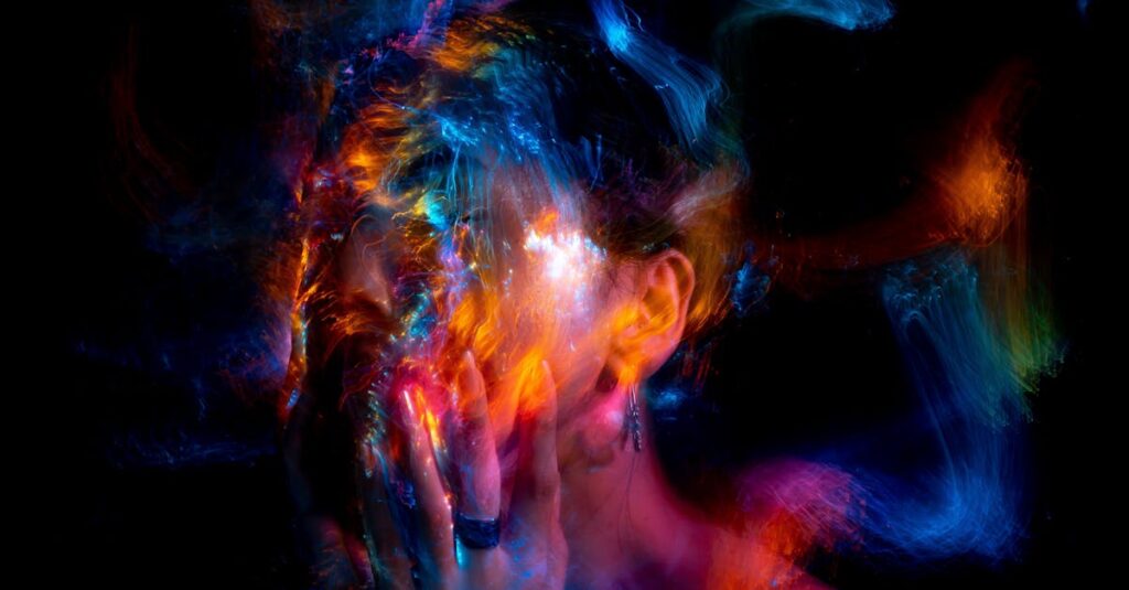 Vibrant long exposure portrait with colorful light painting effects.