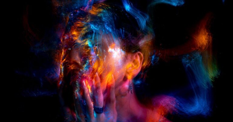 Vibrant long exposure portrait with colorful light painting effects.